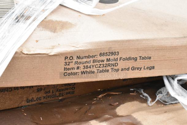 Box showing 32" round blow mold folding table with item #384YCZ32RND; white table top, grey legs.
