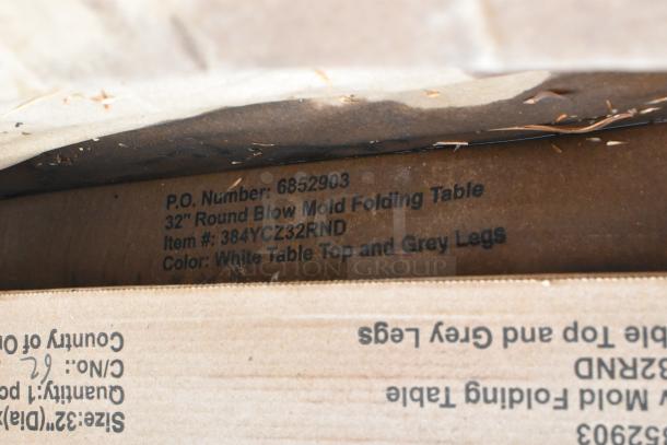 Close-up of packaging for a Lancaster Table & Seating 32" round folding table, item #384YCZ32RND, white top with gray legs.