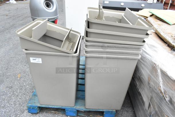 Tan poly trash cans, brand new with scratches and dents. Includes four lids. Five cans shown, stacked on a pallet.
