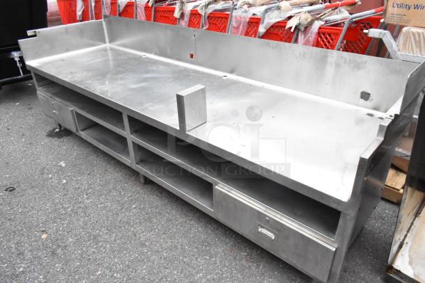 Stainless steel commercial equipment stand with under shelves and 2 drawers, in used condition, featuring a durable build.