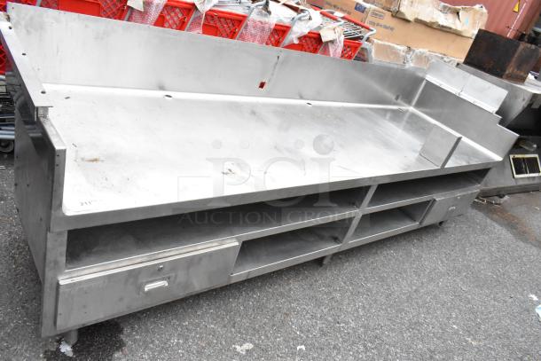 Stainless steel commercial equipment stand with under shelves and 2 drawers. Slight wear, sturdy construction, good for kitchens.