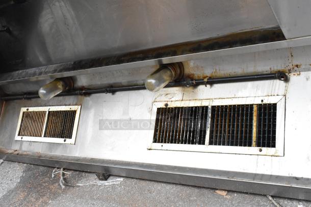 8' metal commercial return air grease hood with visible vents and light, showing signs of use and grease buildup.