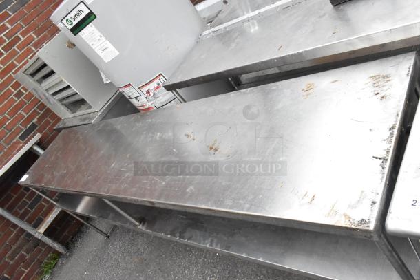 Stainless steel 2 tier overshelf with visible surface wear. Durable construction, ideal for kitchen storage or organization.