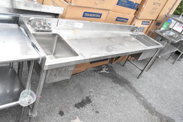 Stainless steel table with single bay sink and dual bay sink, used condition, featuring faucet and hygienic handwashing sign.