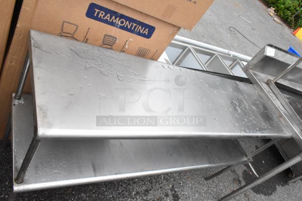 Two stainless steel 2-tier overshelves, wet surface, durable construction. Box marked "Tramontina" in background.