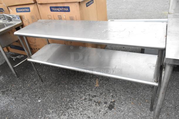 2 Stainless Steel 2 Tier Overshelf with visible water spots, sturdy design, industrial use, labeled "Tramontina" in background.