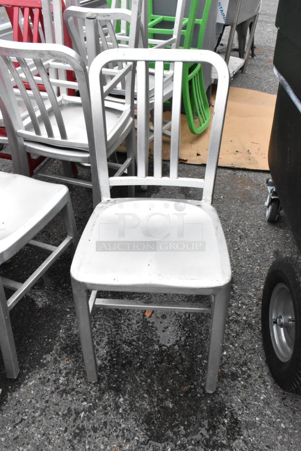Metal dining chair in silver finish, slat back design. In used condition. Set of 14 chairs available for bidding.