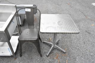 Gray metal Tolix-style chair and chrome finish dining height table, both in used condition.