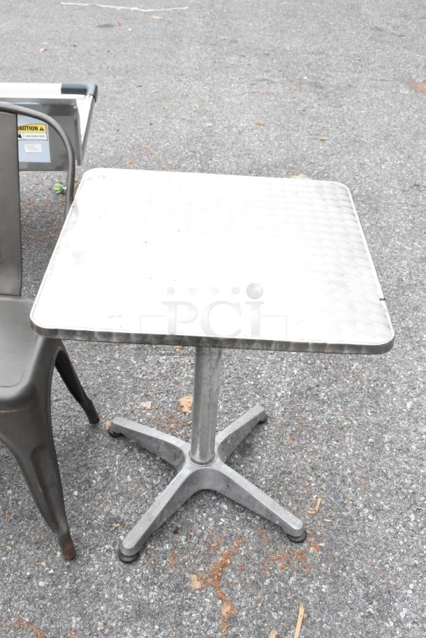 Gray metal Tolix-style chair and chrome dining height table, showing light wear. Ideal for modern décor.