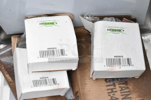 Boxes labeled "Regency 600DB35" indicating components for a Regency stainless steel sink with dual drain boards.