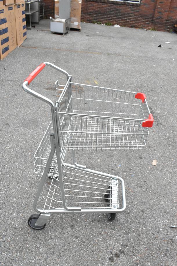 Metal 2-tier shopping cart with red handles, on commercial casters, brand new, scratch and dent condition.