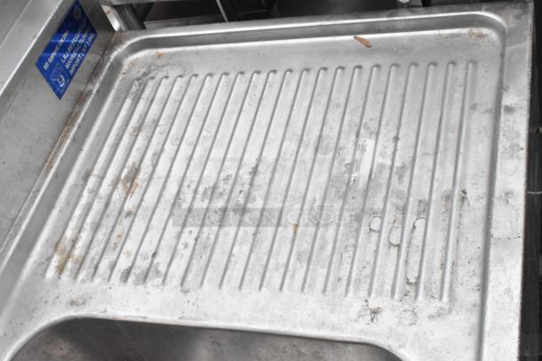 Stainless steel 3 bay bar sink with dual drain boards, visible wear, includes faucets and handles, labeled for J&J Restaurant Manufacturing Import.