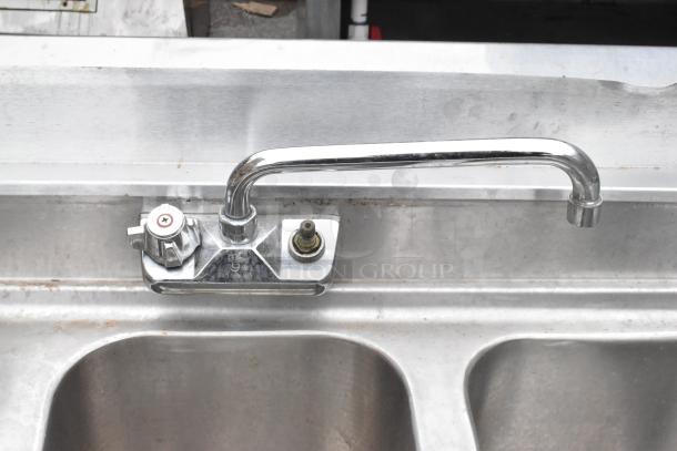 Stainless steel 3 bay bar sink with dual drain boards, faucets, and handles, in good condition.