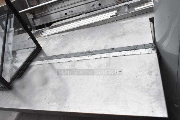 Stainless Steel 2 Tier Overshelf, industrial-grade with visible weld joints, sturdy construction, minor surface marks.