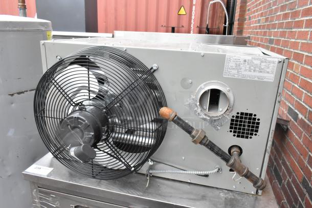 Modine HD 100AS0111FBAN commercial heater, 115V, 1 phase. Features fan and visible piping. Metal exterior in good condition.