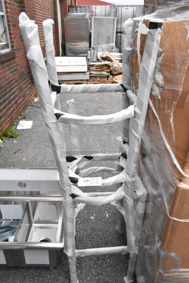 Two brand new metal bar height chair frames, no cushions or backrests, wrapped and marked as scratch and dent.