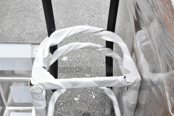 Two brand new metal bar height chair frames, no cushions or backrests, wrapped and marked as scratch and dent.
