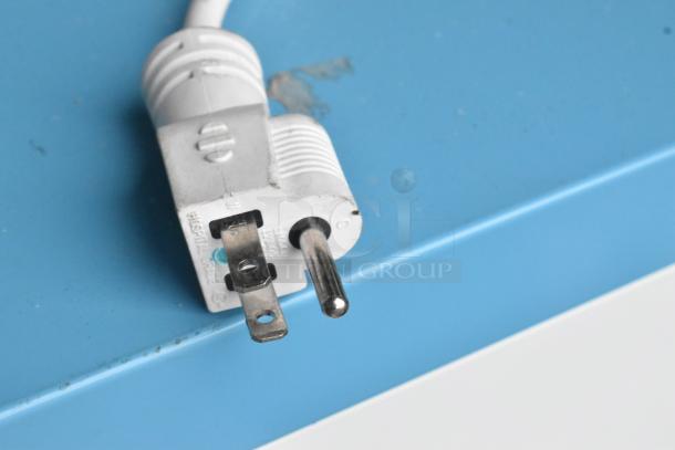 Hospital-grade power plug of Accucold ARG6PV456 cooler, 115 volts, 1 phase, white, close-up.