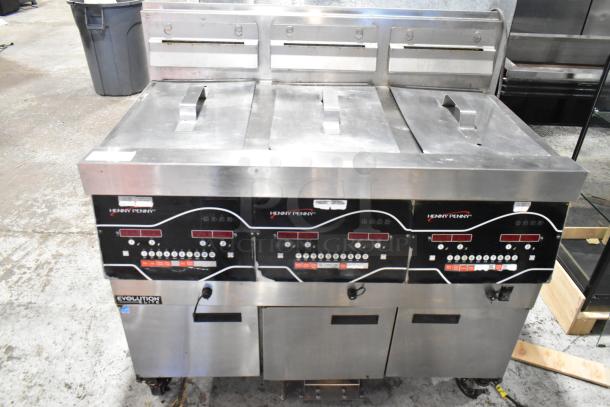 2016 Henny Penny EEG-243 FFFX ST stainless steel 3-bay deep fryer with filtration system, natural gas powered, on casters.
