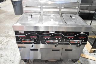 2016 Henny Penny EEG-243 FFFX ST Stainless Steel Commercial Floor Style Natural Gas Powered 3 Bay Deep Far Fryer w/ Filtration System and 3 Lids on Commercial Casters. 225,000 BTU. - Item #1203274