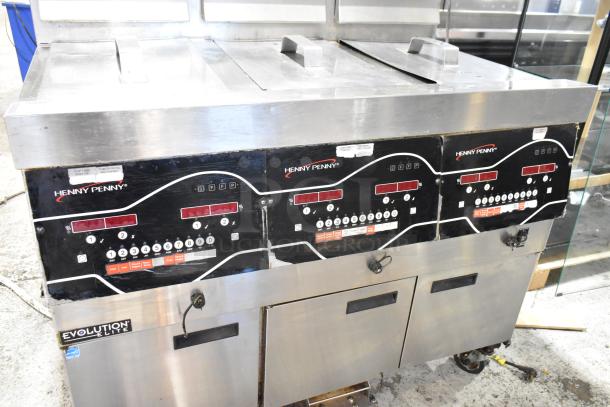 2016 Henny Penny EEG-243 FFFX ST stainless steel 3-bay deep fryer with filtration system, lids, on casters, 225,000 BTU.