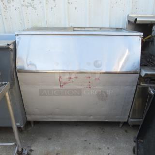Commercial ice bin, 52x32x51 inches, stainless steel, visible wear and marks, used condition, ideal for restaurant use.