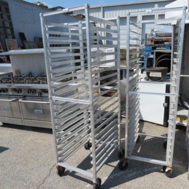 Aluminum speed rack on casters, 20.5x26x69 inches, holds multiple trays, industrial-grade, good condition.