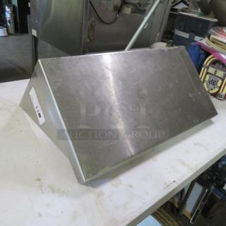 Stainless steel shelf with two brackets, 24x12x12 inches, slight surface wear, item tag visible on the side.