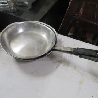 10.5-inch stainless steel sauté pan with a long handle, showing signs of wear. Ideal for versatile cooking needs.