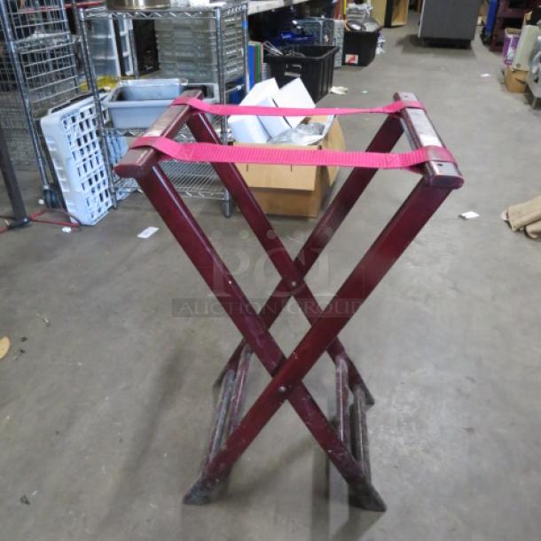 Wooden tray stand with red fabric straps, vintage design, moderate wear, sturdy construction.