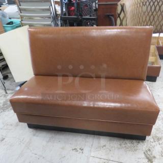 Brown cushioned single-sided booth, 48x25x36 inches, in good condition, ideal for restaurant or home use.