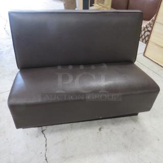 Chocolate brown cushioned booth, single-sided; dimensions 48x26x36 inches; good condition, ideal for restaurants.