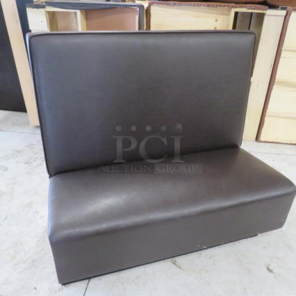 Single-sided chocolate brown cushioned booth, 48x27x45 inches, excellent condition, ideal for restaurant seating.
