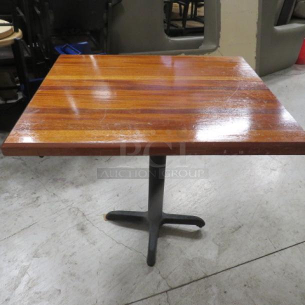 Solid wood butcher block table on a pedestal base, 36x30x30 inches. Glossy finish, sturdy construction, ideal for dining.