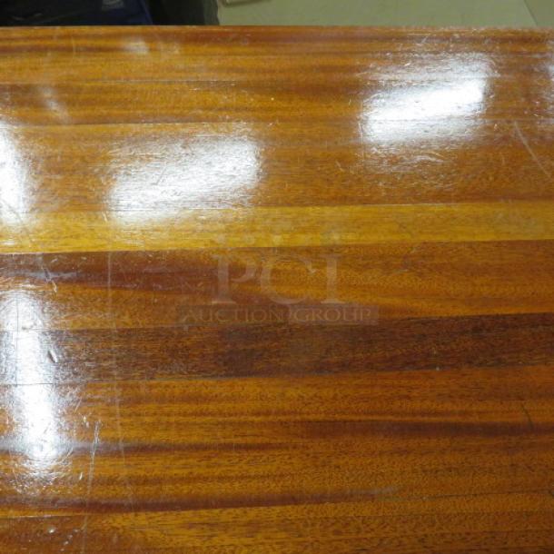 Solid wood butcher block table top on pedestal base, 36x30x30 inches. Features a glossy finish with visible wood grain.