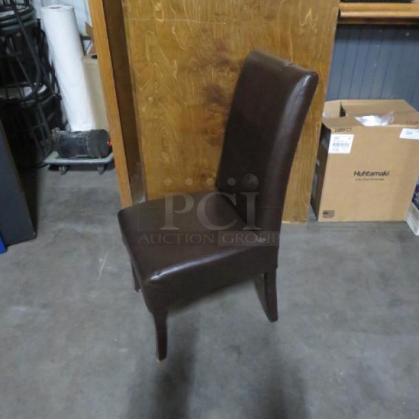 Brown cushioned high backed chair with wooden legs, in good condition. Suitable for dining or office use. Model: 2XBID.