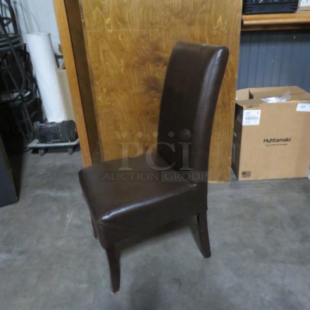 Brown cushioned high-backed chair with wooden legs, in good condition. Ideal for dining or accent seating.