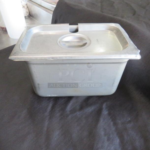 1/4 Size 6 Inch Deep Hotel Pan with Lid; metal construction, slightly used condition, suitable for food service.