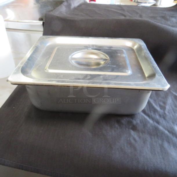 One 1/2 size, 4-inch deep hotel pan with lid, stainless steel, good condition, suitable for food service.