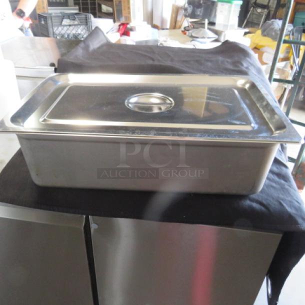 Full-size 4-inch deep stainless steel hotel pan with lid, excellent condition, ideal for catering or restaurant use.