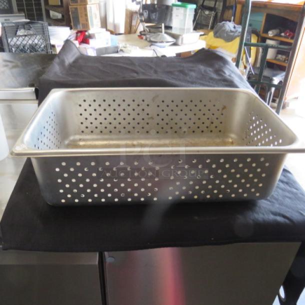 One full-size, 6-inch deep perforated hotel pan in metal. Used condition, with visible perforations for drainage.