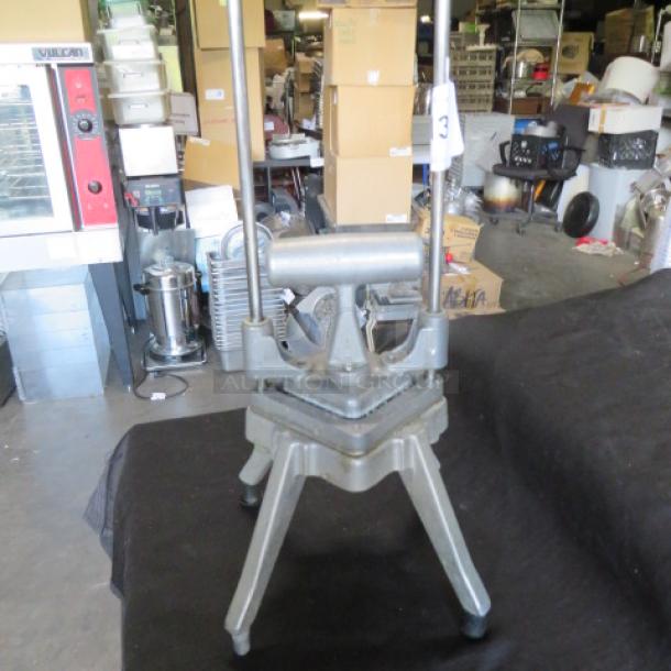 Nemco vegetable cutter in used condition, featuring sturdy metal construction and lever design for efficient slicing.