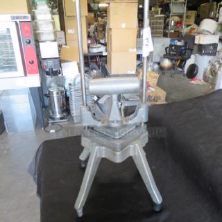 Nemco vegetable cutter in used condition, featuring sturdy metal construction and lever design for efficient slicing.