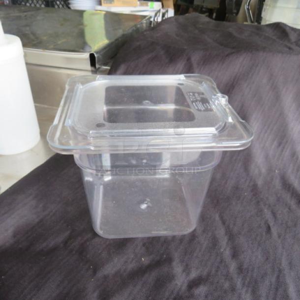 1/6 size 6" deep clear food storage container with lid, excellent condition, marked "2XBID," ideal for kitchen use.