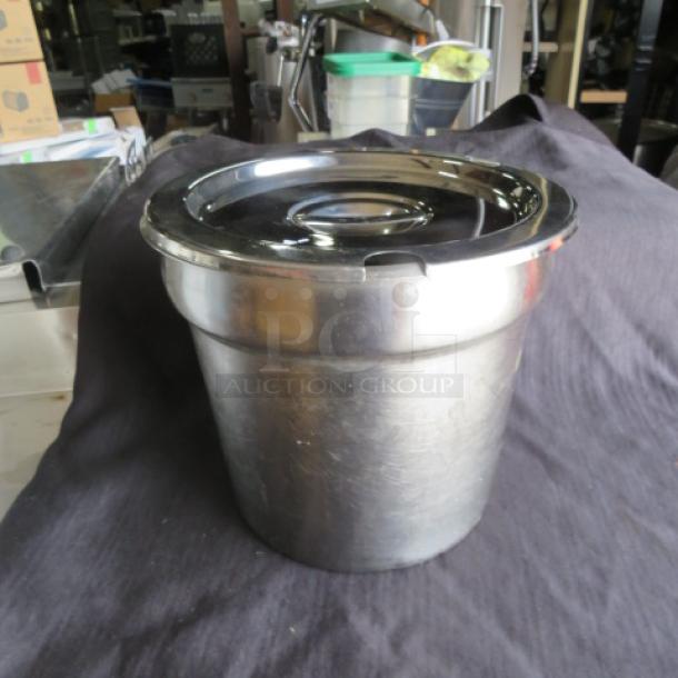 Stainless steel soup well with lid in used condition, featuring a polished finish and sturdy construction.
