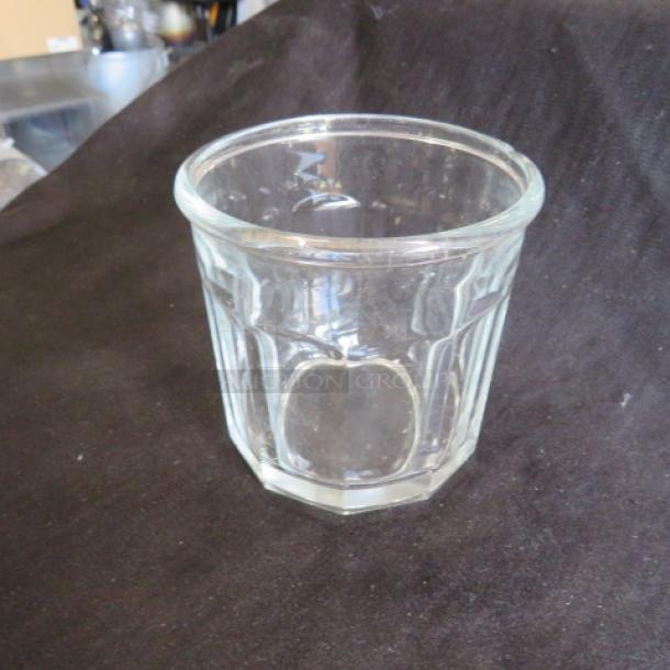 Clear glass rocks glass with faceted design, in excellent condition. No visible markings. Suitable for cocktails or spirits.