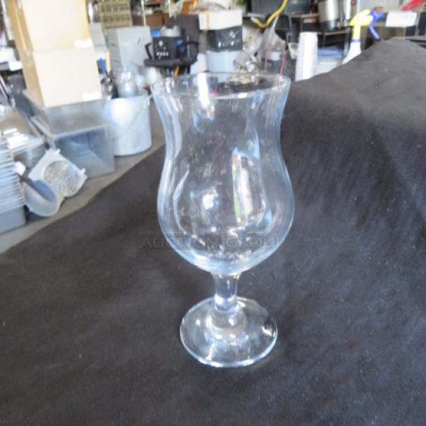 Clear hurricane glass with elegant curved shape, 7XBID model. Excellent condition, no visible chips or scratches.