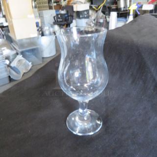 Clear hurricane glass with elegant curved shape, 7XBID model. Excellent condition, no visible chips or scratches.