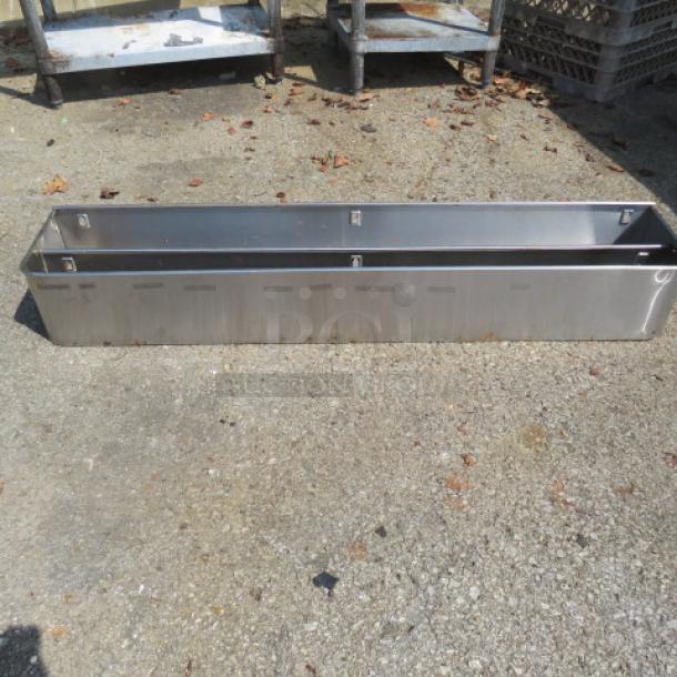 Stainless steel double bottle rail, 46x9x7 inches, durable, sleek design, ideal for bar use, good condition.