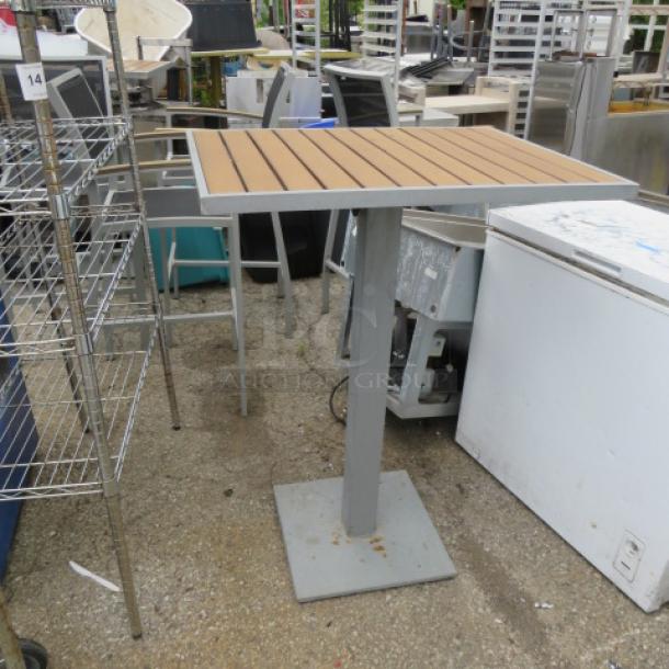 BFM bar height patio table, synthetic teak top, aluminum frame, 32x24x43 inches, used condition.